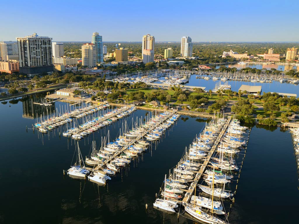 An aerial view of a harbor in St. Petersburg, Florida dotted with charter fishing boats on a lovely sunny day