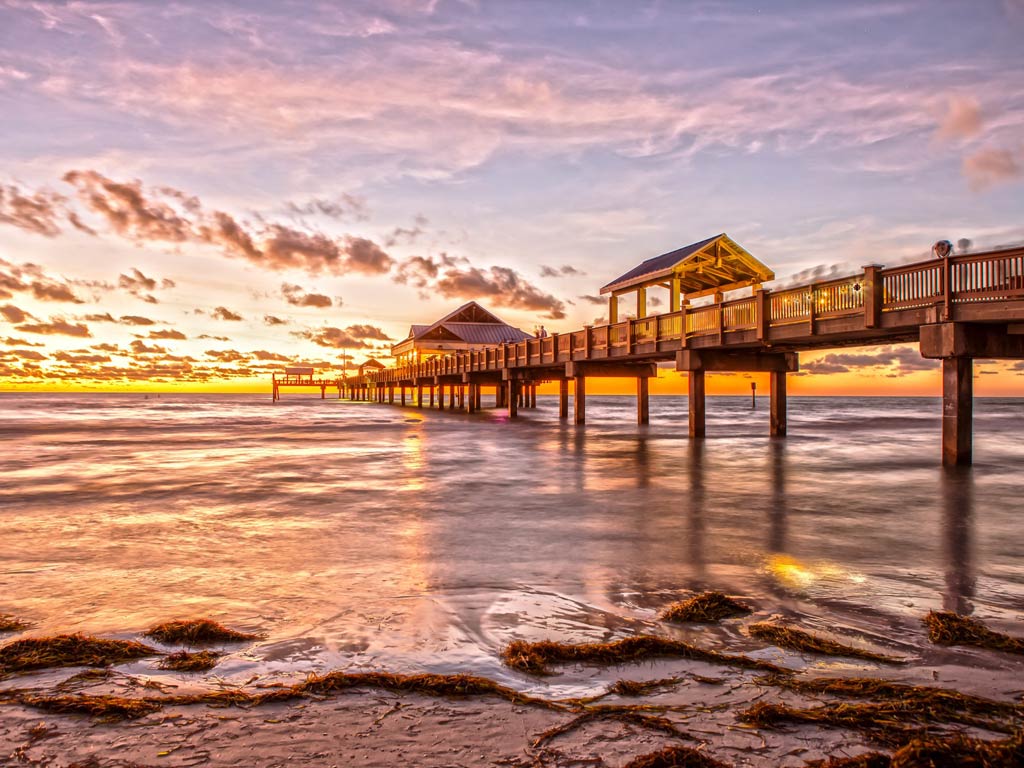 A gorgeous view of pier and beach in Tampa Bay at sunset