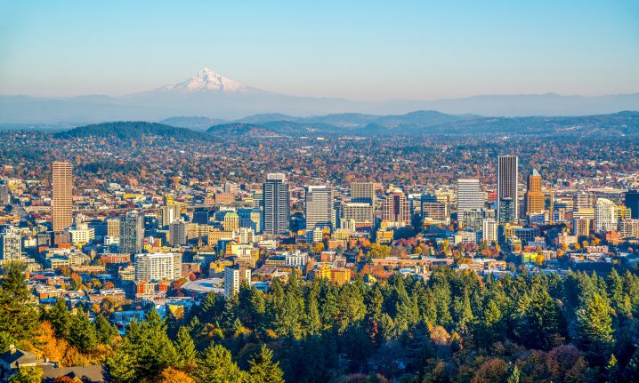 An aerial view of Portland, Oregon with mountains in the distance