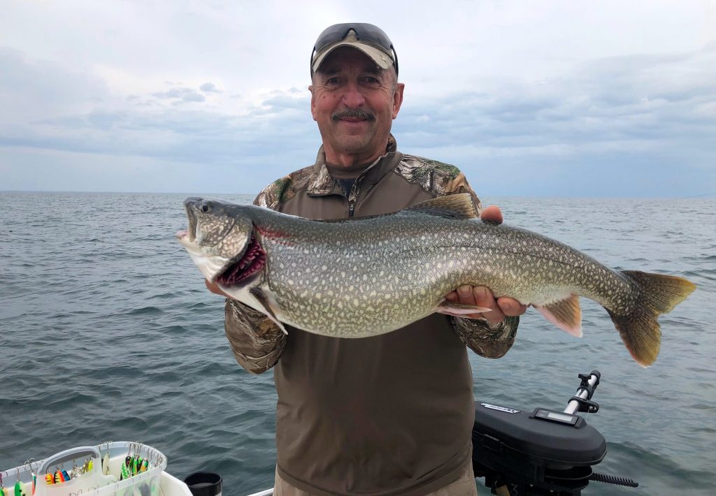 lake trout lake ontario Man with lake trout on lake ontario