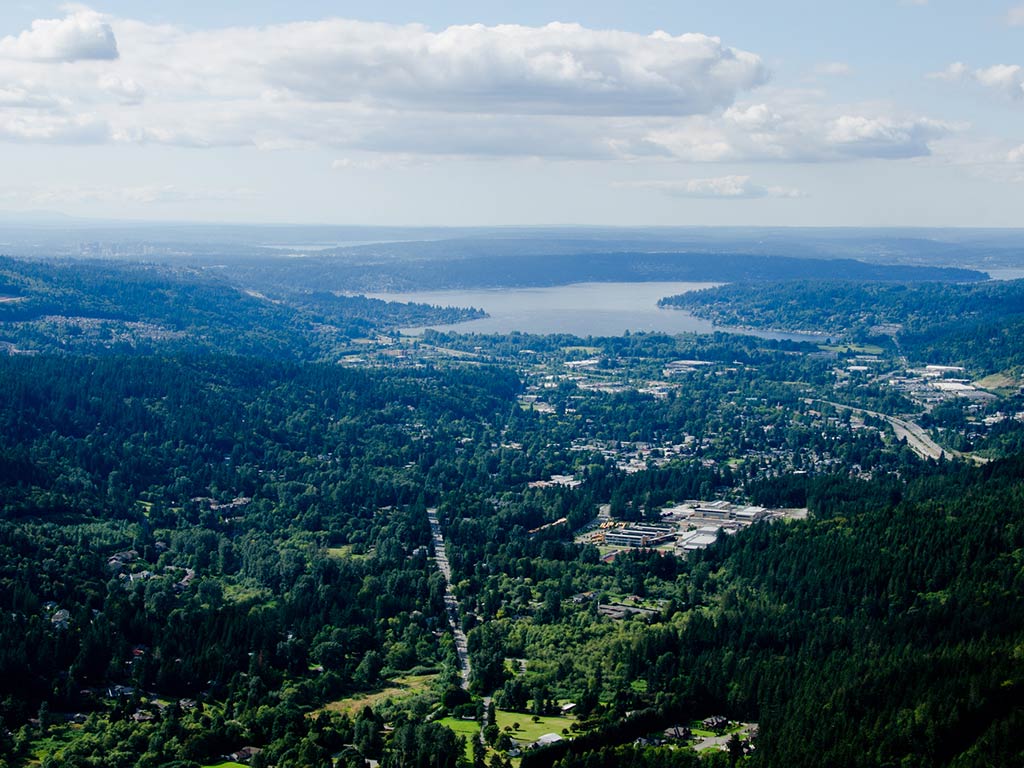 An aerial view of a lake in Washington state, with the town of Issaquah visible in the foreground.