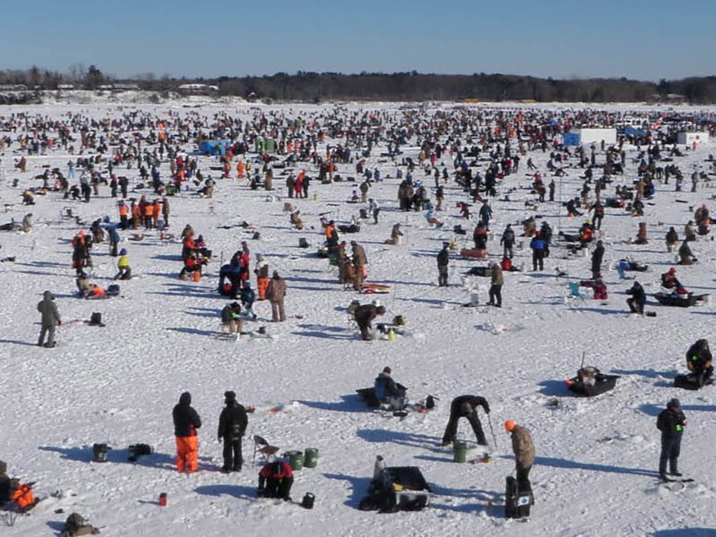 A view across a frozen lake of hundreds of anglers participating in the annual Brainerd Jaycee Ice Fishing Extravaganza in Brainerd, MN.