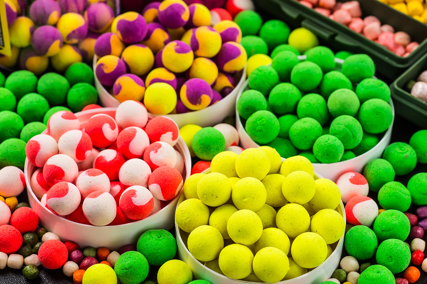A variety of different colourful carp fishing bait bollies.