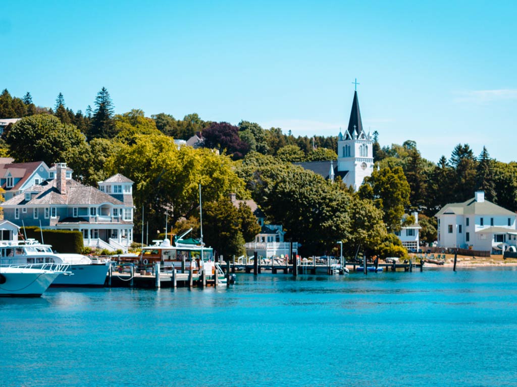 The marina on Mackinac Island, with trees and a church in the distance