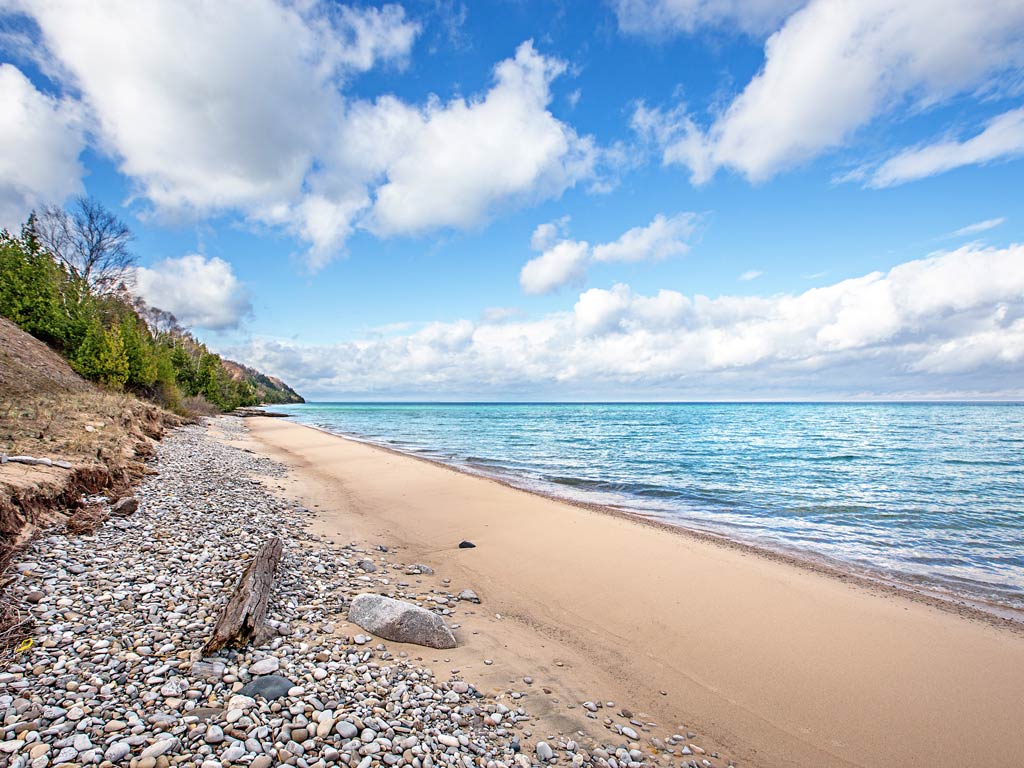 A beach on the Great Lakes, with blue water on the right
