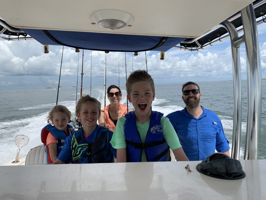 Family laughing and riding a boat