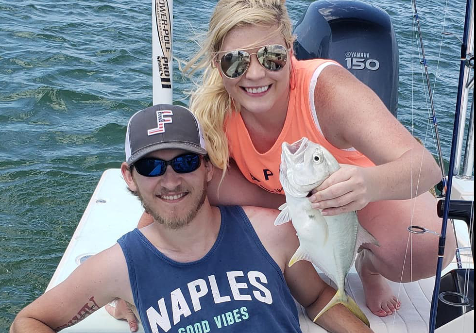 man and woman on boat with jack crevalle