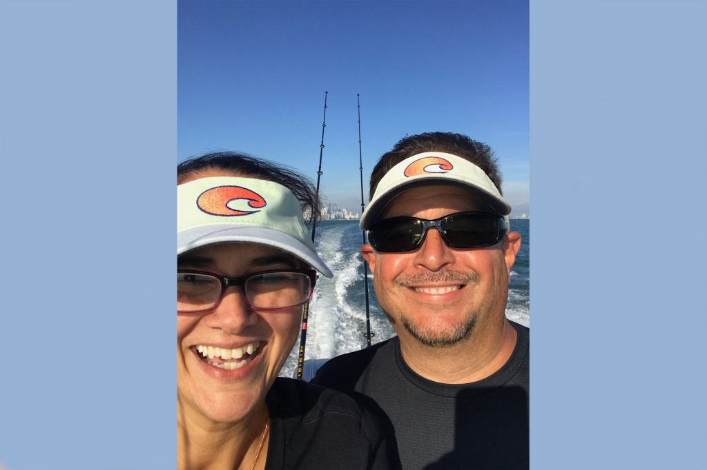 Man and woman smiling at sea