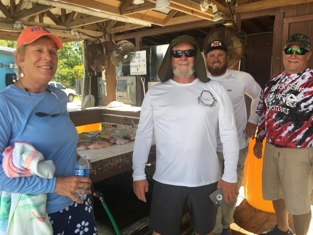 Family group at the dock with fish