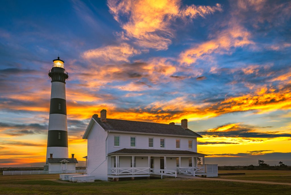 Cape Hatteras Lighthouse with a beautiful sunrise in the background.