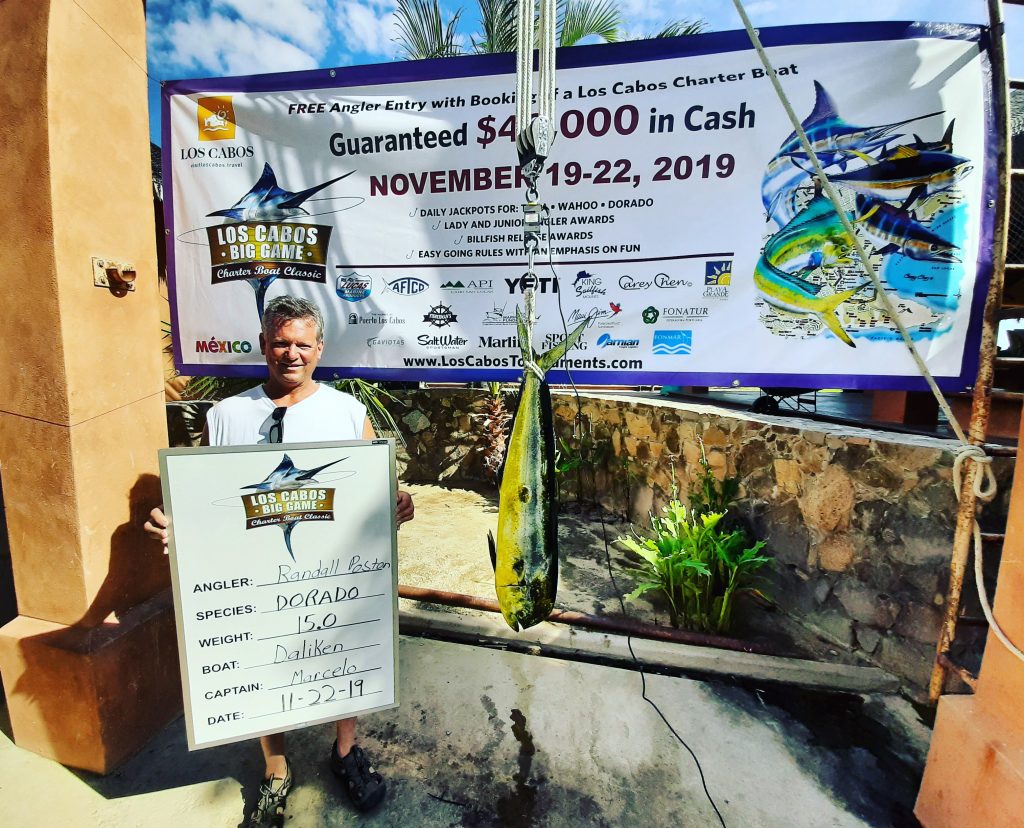 Man with trophy mahi mahi at a fishing tournament