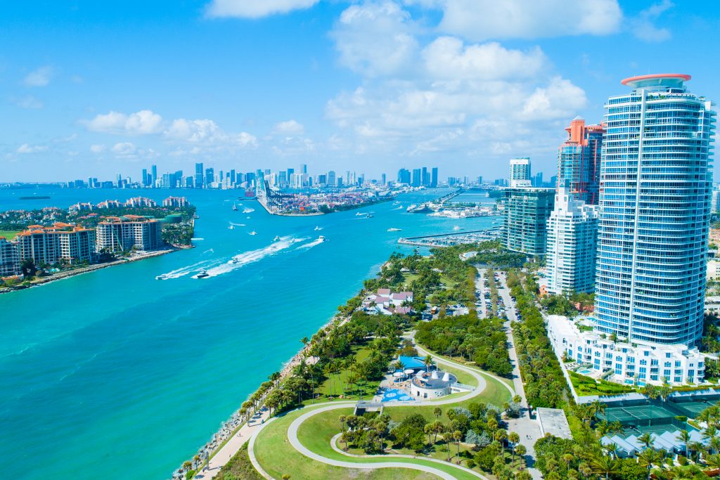 An aerial view of the Instracoastal Waterway in Miami, FL, with charter fishing boats in the sea.