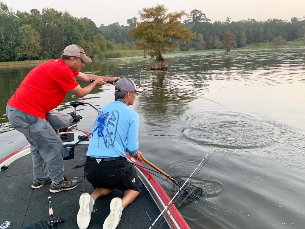 Two anglers pulling in a fish out of Pinopolis.