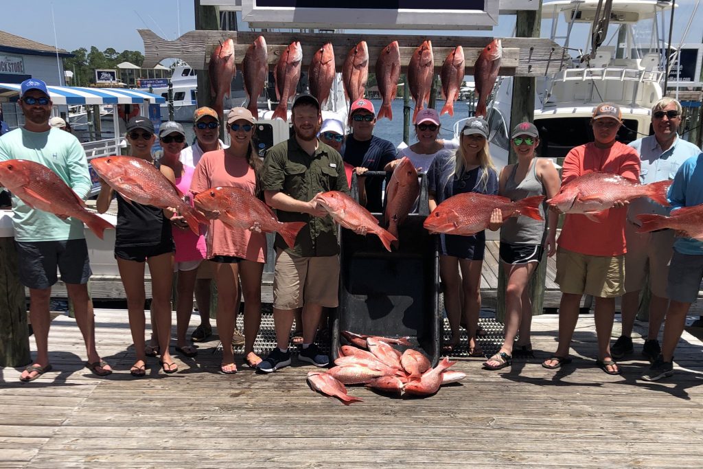 A large group of anglers holding Red Snapper caught on a Corpus Christi Party Boat fishing trip