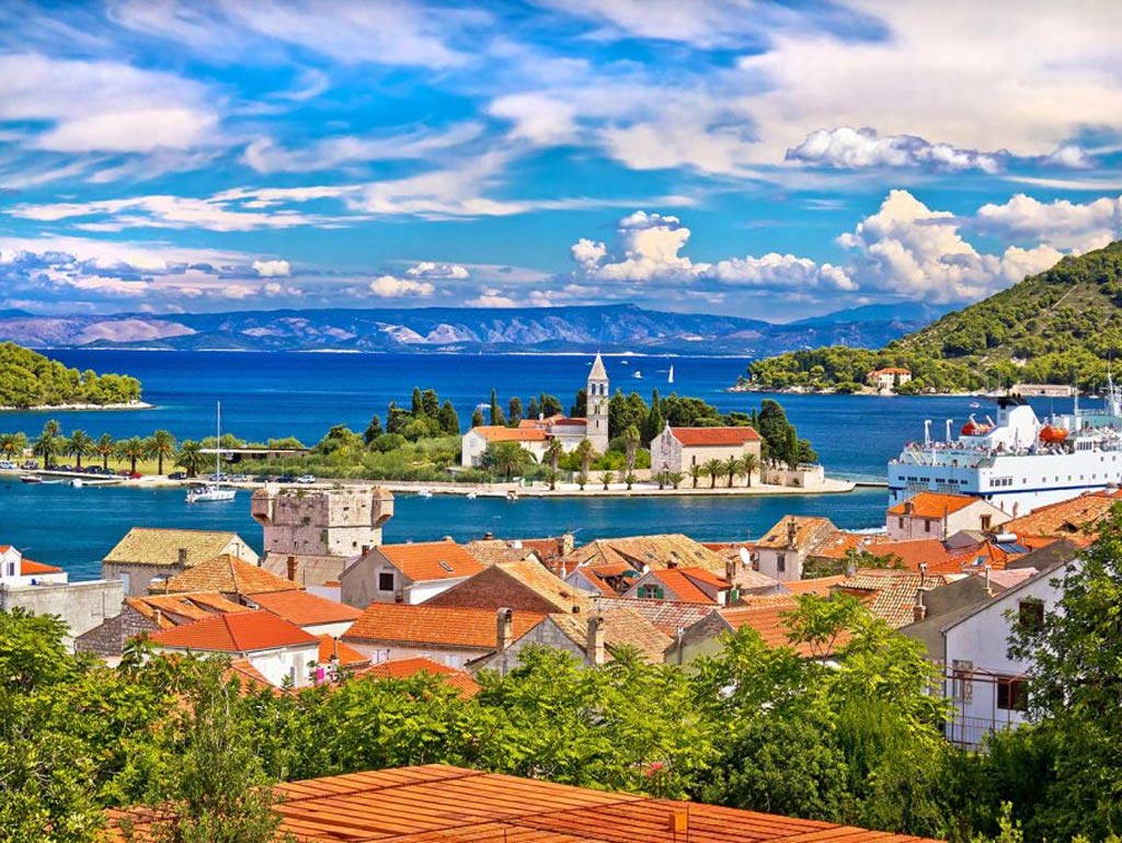 A view of the island of Vis looking towards the Adriatic Sea with a church in the middle