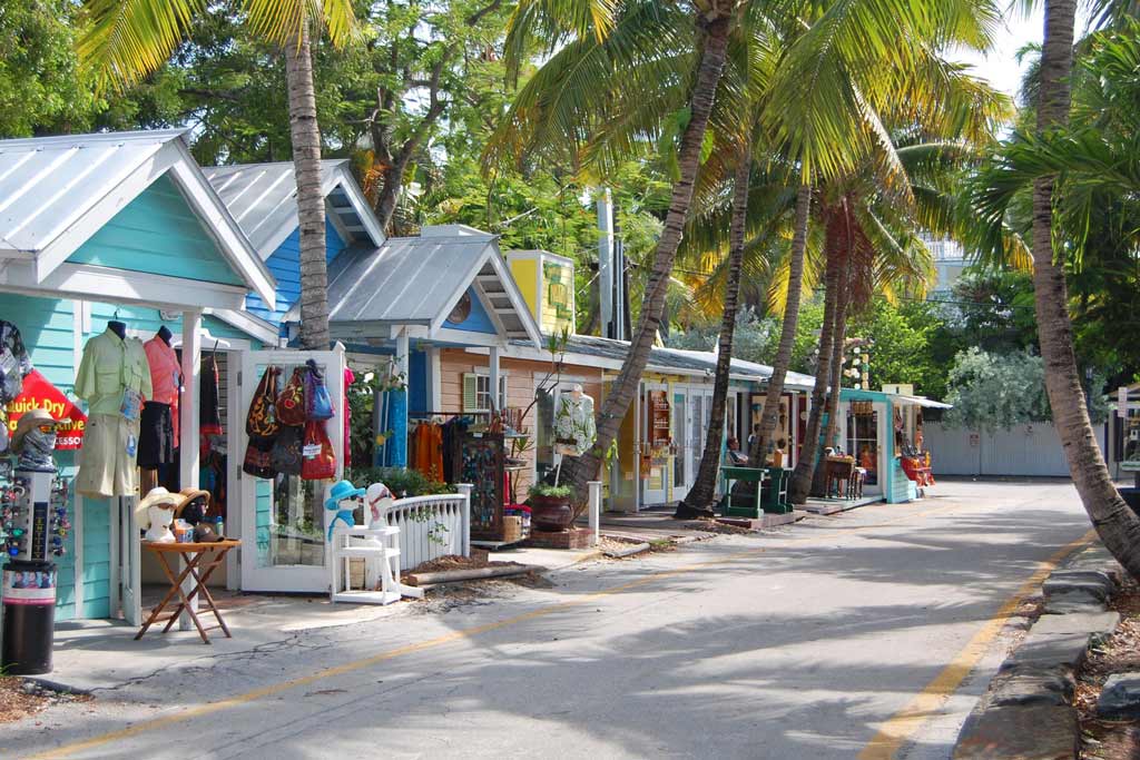 A street in Key West with several shops and small restaurants lined up