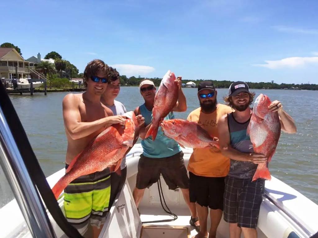Anglers posing with Snapper catches on a well-equipped charter boat docked at the Oceanside Harbor