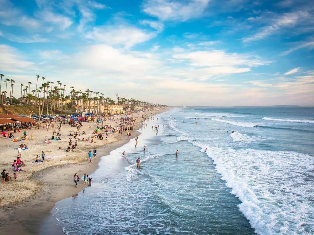 Beachgoers enjoying the beautiful weather at Oceanside Beach.