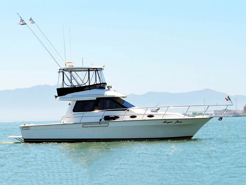 An offshore fishing boat making its way toward Ensenada harbor during a bright and sunny day