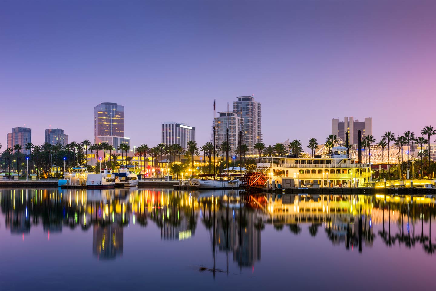 A view of the Long Beach waterfront with lights reflecting on the water.