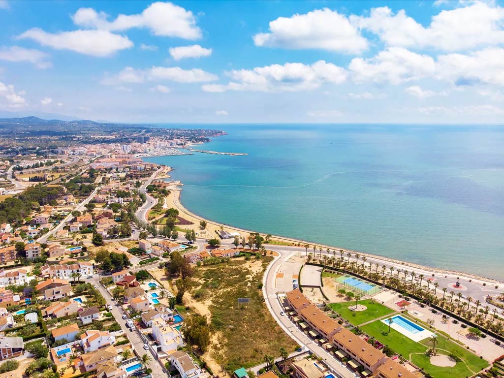 An aerial view of the coastline of L'Ampolla, showing the coastline and beach