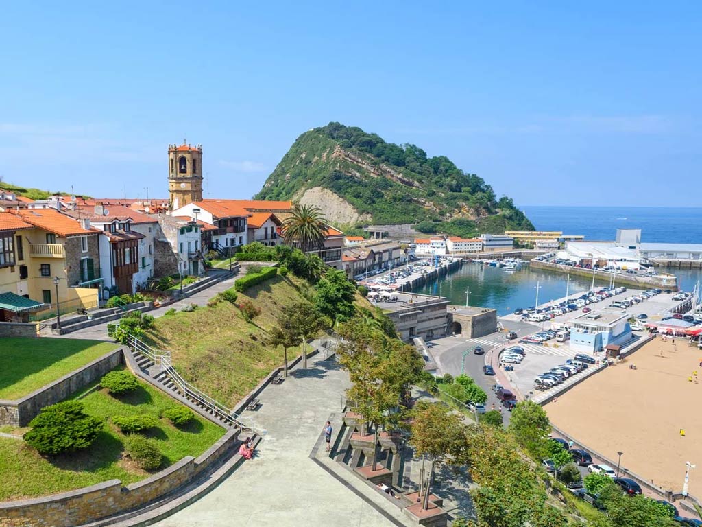 A view of Getaria's scenery, with the ocean and charter boats to the right
