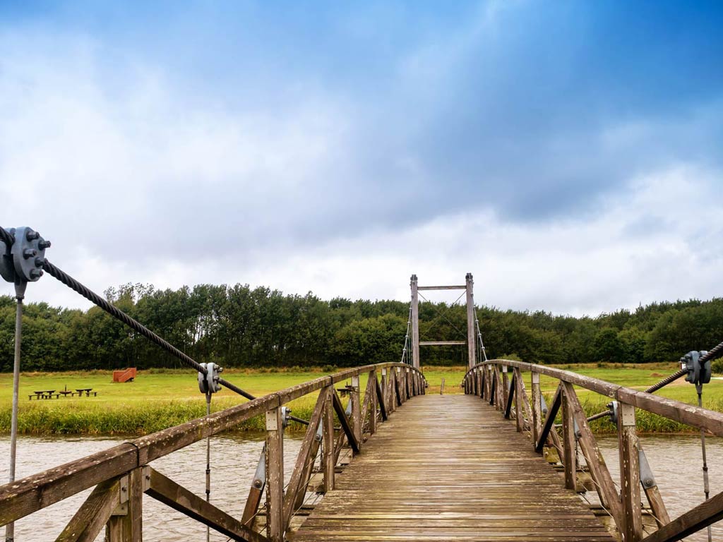 A photo of the bridge over the Skjern River, a mecca for Salmon fishing in Denmark taken on a cloudy spring day