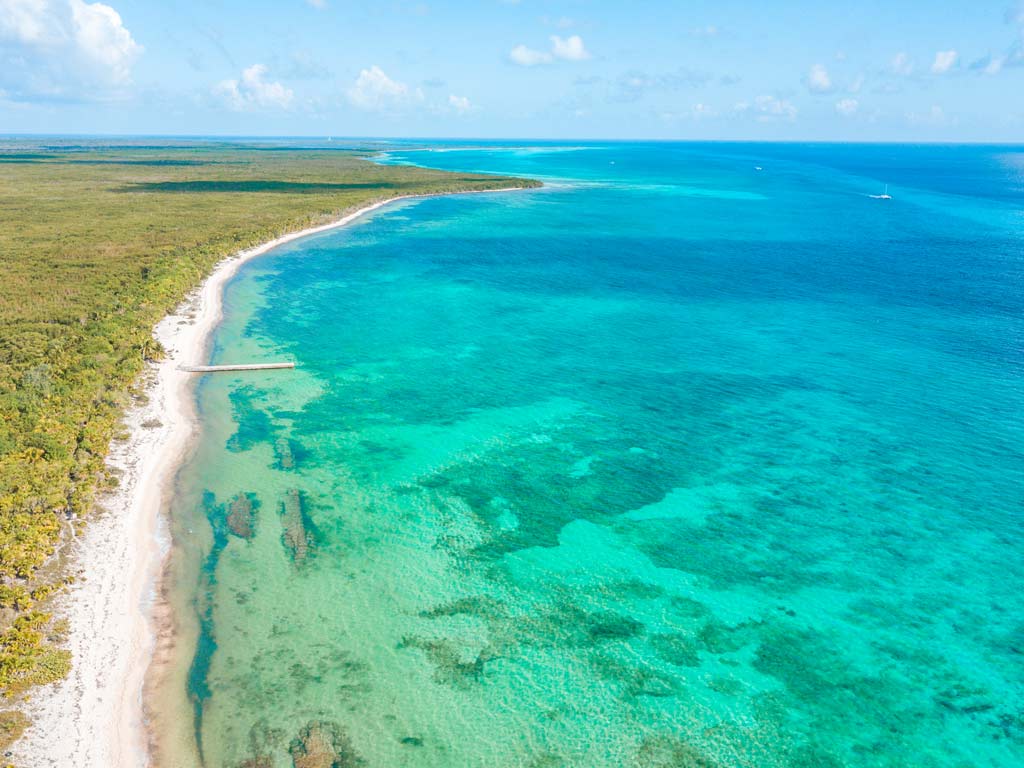 An aerial photo of a beach on Cozumel Island and turquoise ocean waters