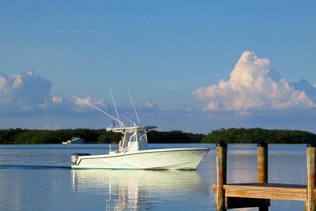 A center console fishing boat on the calm waters of Florida keys