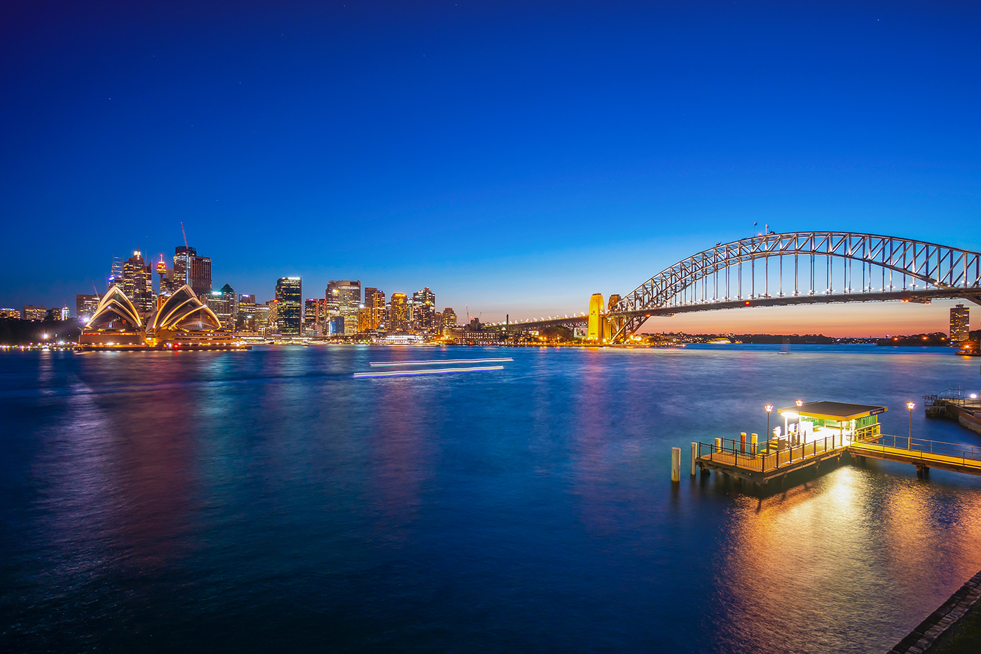 Beulah Street Wharf at night, with the Sydney Opera House and Harbour Bridge in the distance