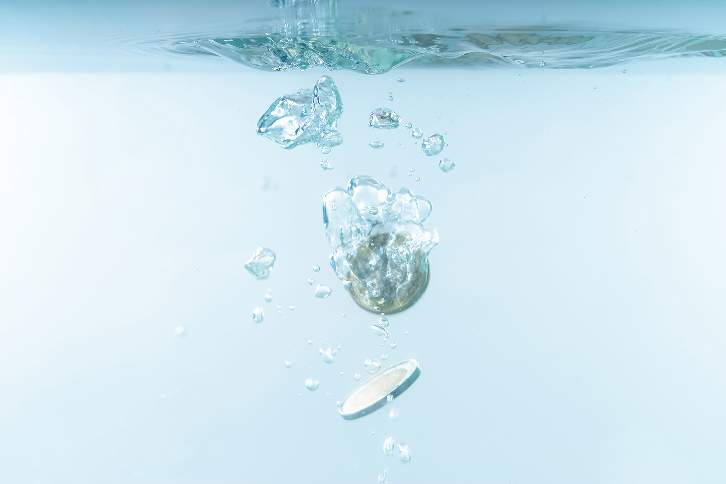 coins falling into water