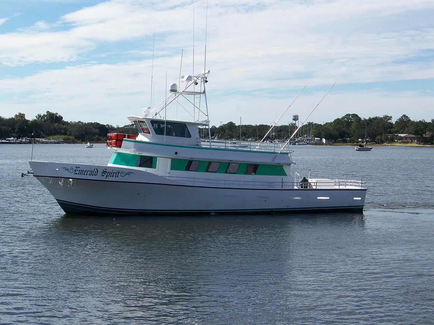 A party boat named the "Emerald Spirit" making its way along the bay waters in Perdido Bay