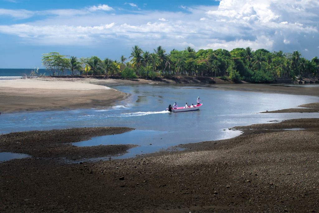 A small panga boat makes its way back to shore in Quepos, Cost Rica