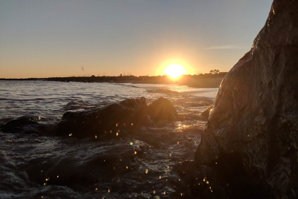 Dauphin Island's rocky shoreline waters at sunset