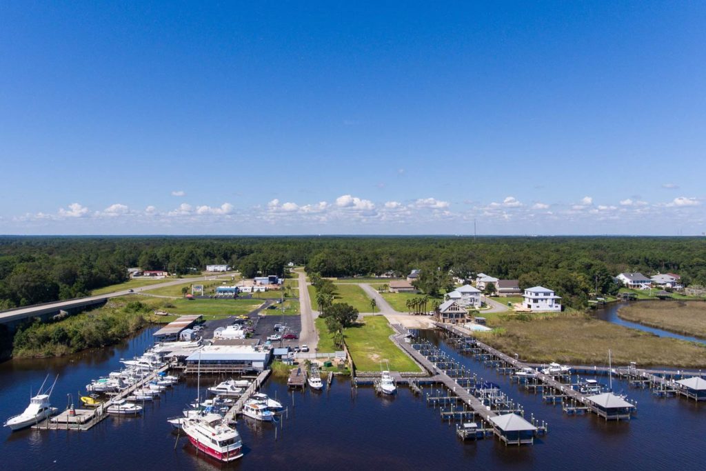A view of one of Dauphin Island's marinas on a sunny day, with charter vessels docked