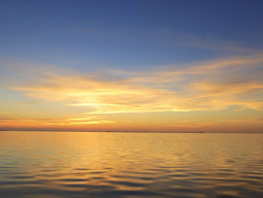 A beautiful red and orange sunset over open waters.