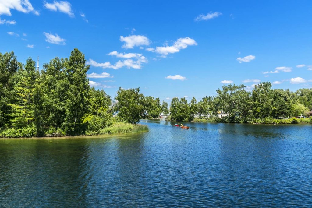 A view of productive fishing and recreational grounds near the Toronto Islands, with two kayaks in the distance on a sunny day.