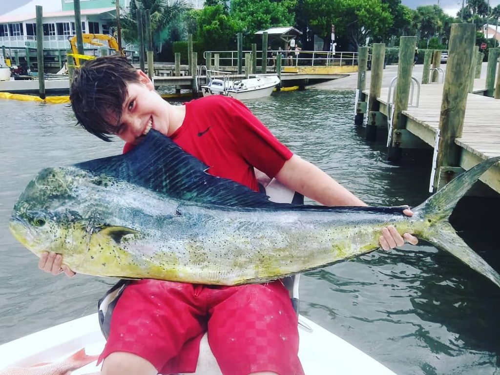 Young angler holding a big Mahi Mahi