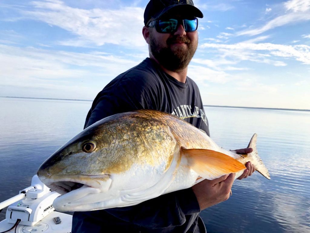 Angler holding a big Redfish