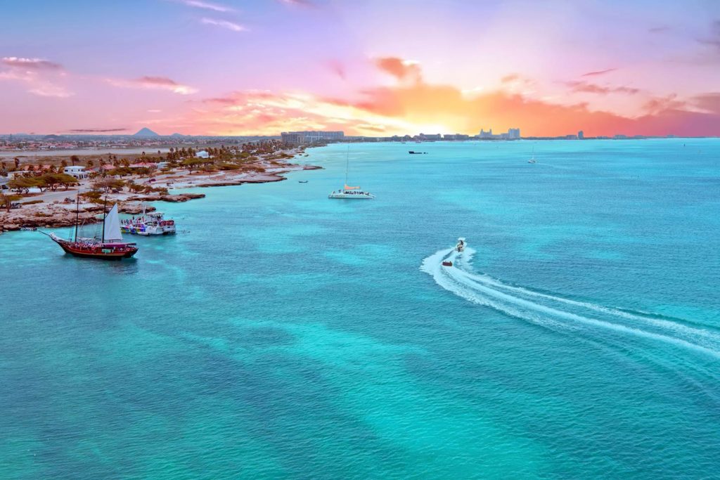 A view of the Caribbean Sea and Aruba's shoreline at sunset.