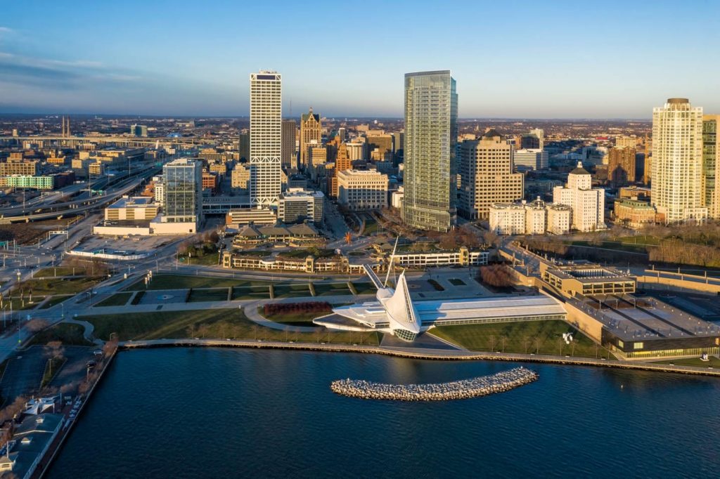 An aerial view of Milwaukee's skyline during the day with Lake Michigan in the foregeound