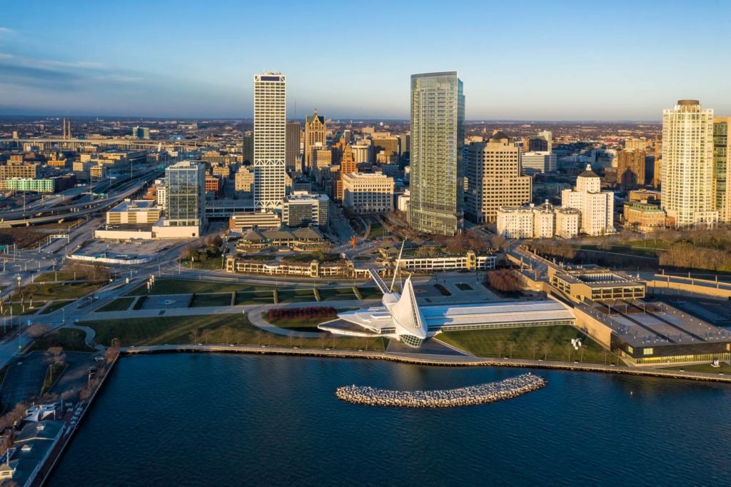 An aerial view of Milwaukee's skyline during the day with Lake Michigan in the foregeound