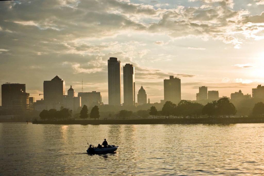 A charter boat on Lake Michigan at dusk with the Milwaukee skyline in the background