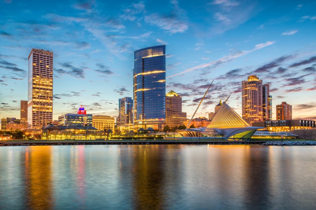 A view of Milwaukee's city skyline at dusk, with Lake Michigan in the foreground