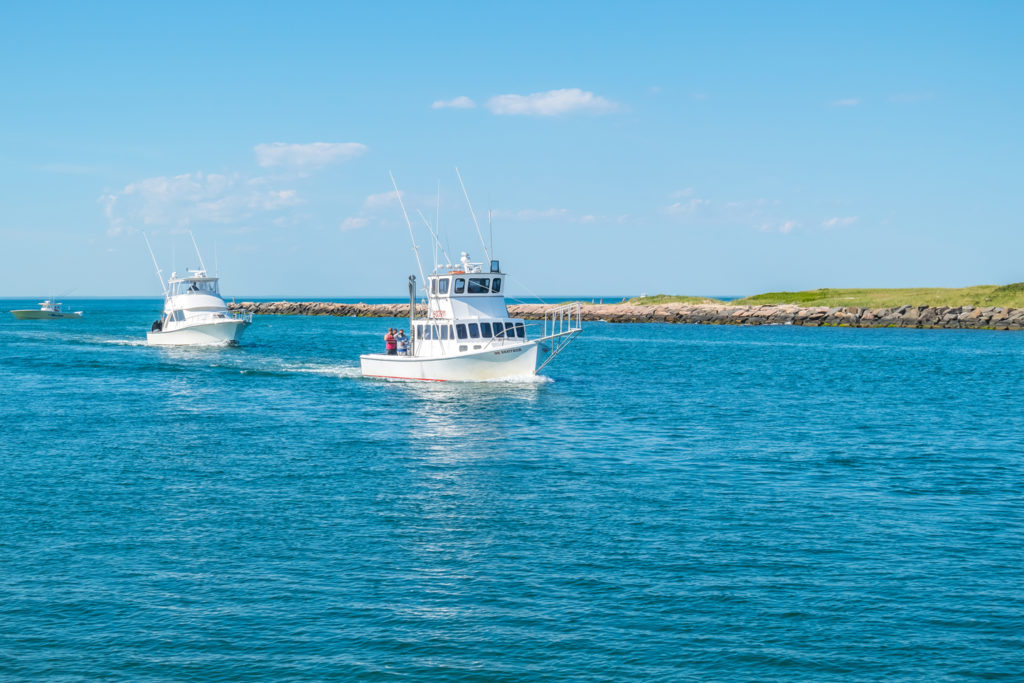 Two charter boats out on the water on a sunny day near Montauk
