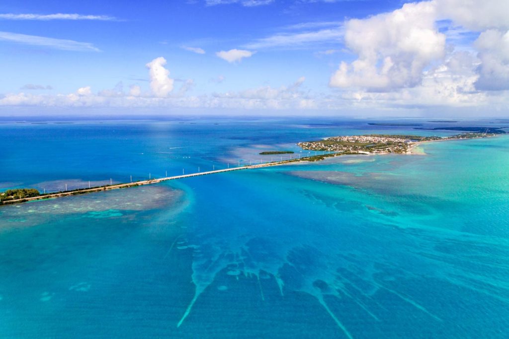 An aerial shot of the Florida Keys and the bridge on a sunny day.