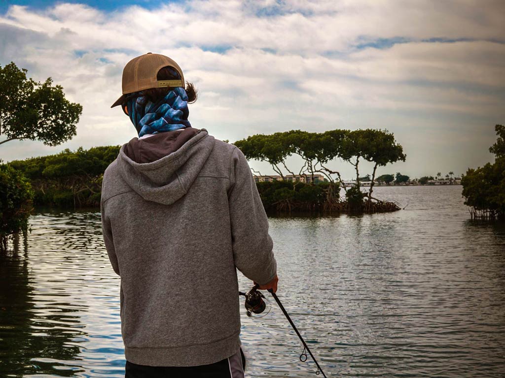 A photo featuring a fly fishing angler casting in the inshore water and hoping to catch a Snook