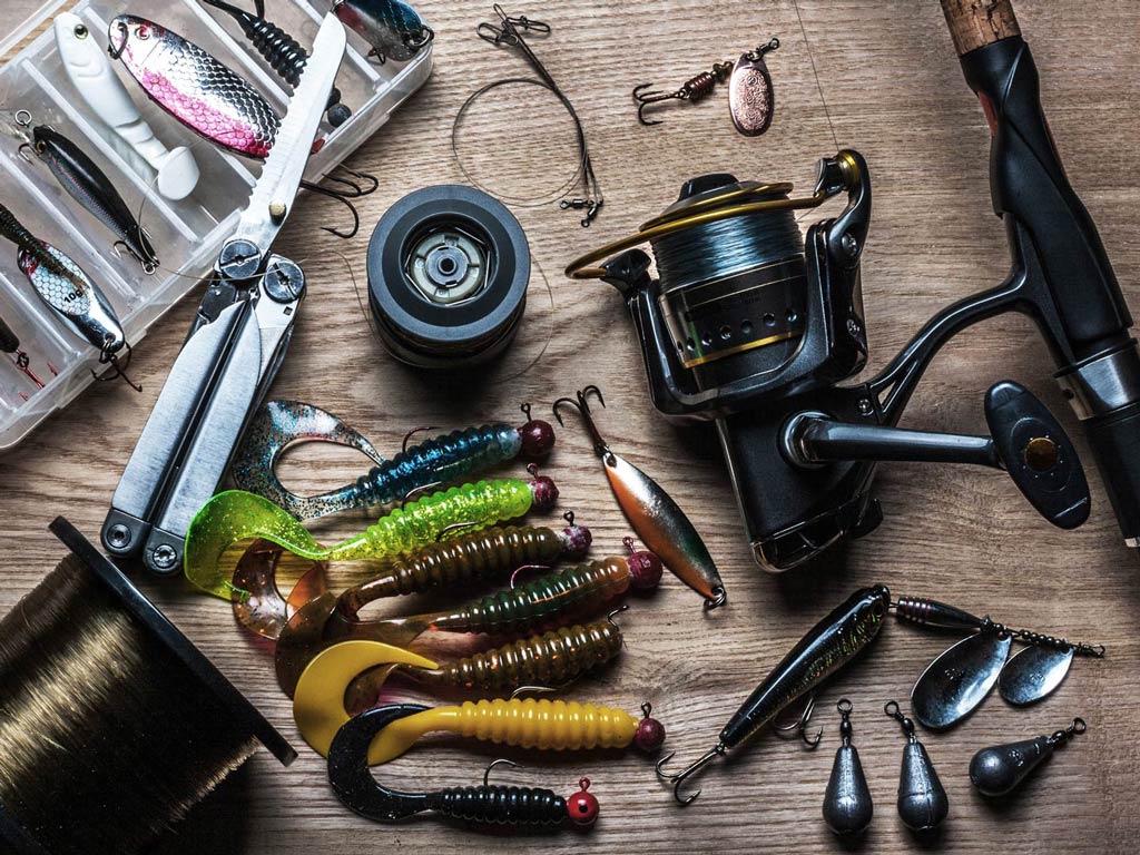 A photo featuring fishing rod with tackle laid out on a table