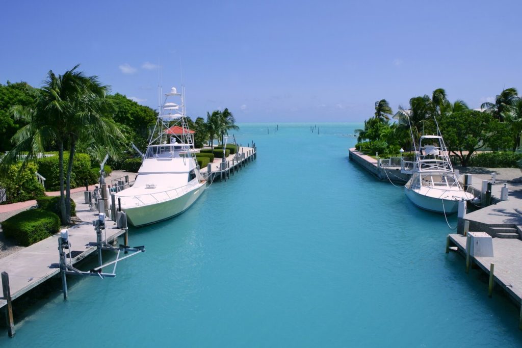 Florida Keys fishing boats in a marina with the open sea in the background