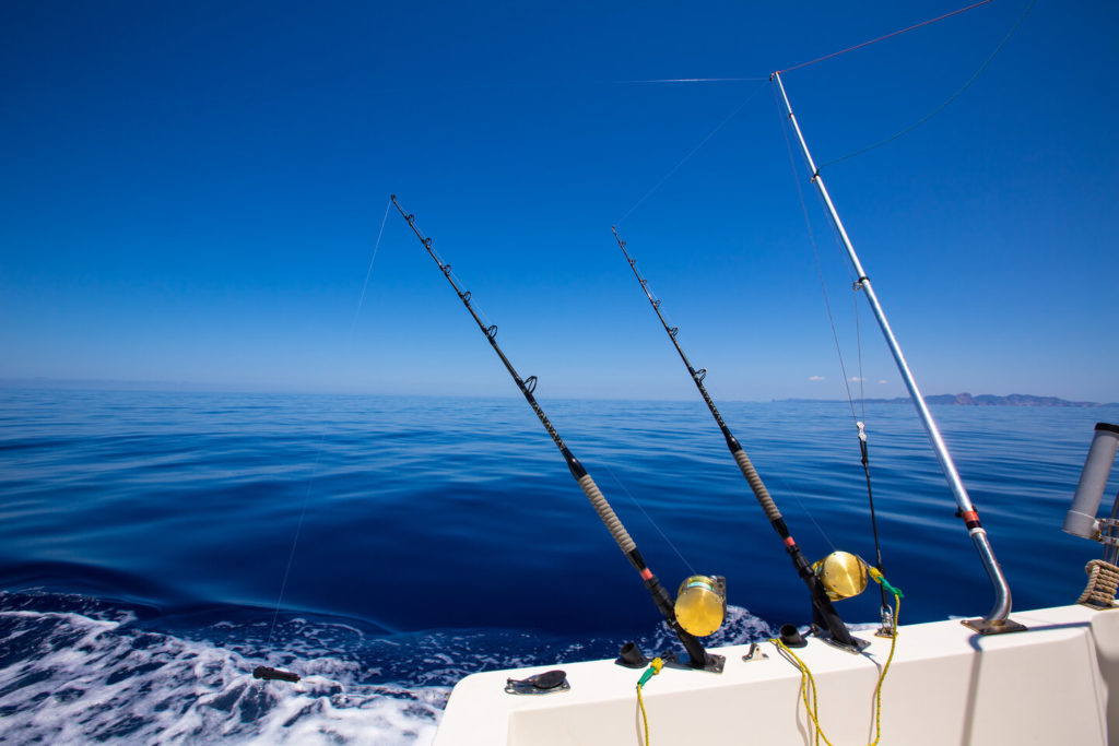 Fishing rods on a boat with the waters of the Gulf of Mexico in front of the boat, Florida